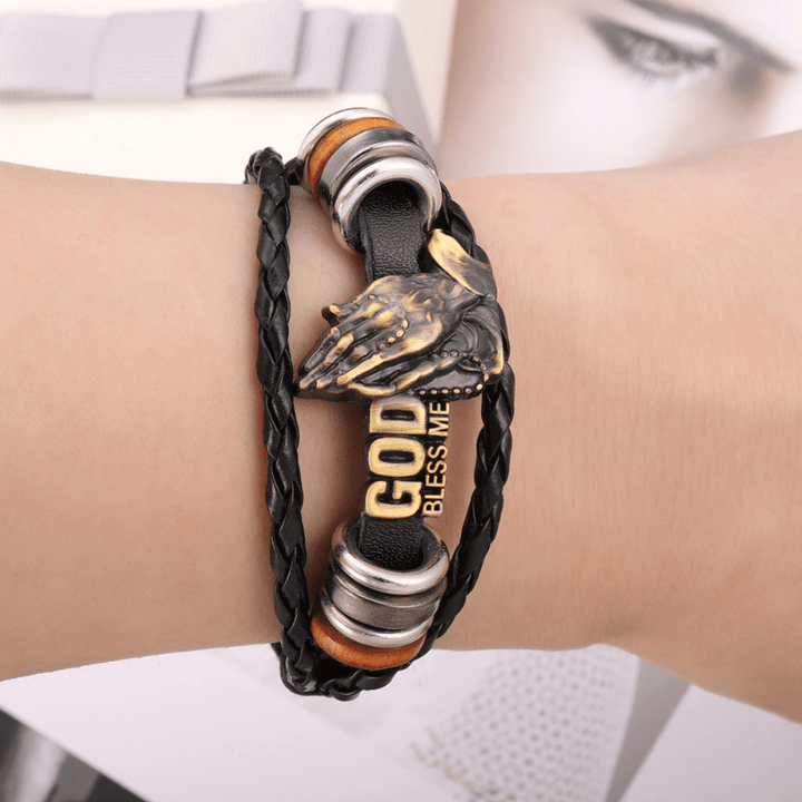 Christianartworkshop Pulsera estilo retro con manos rezando y la inscripción "DIOS ME BENDIGA", diseño trenzado negro. - image 1