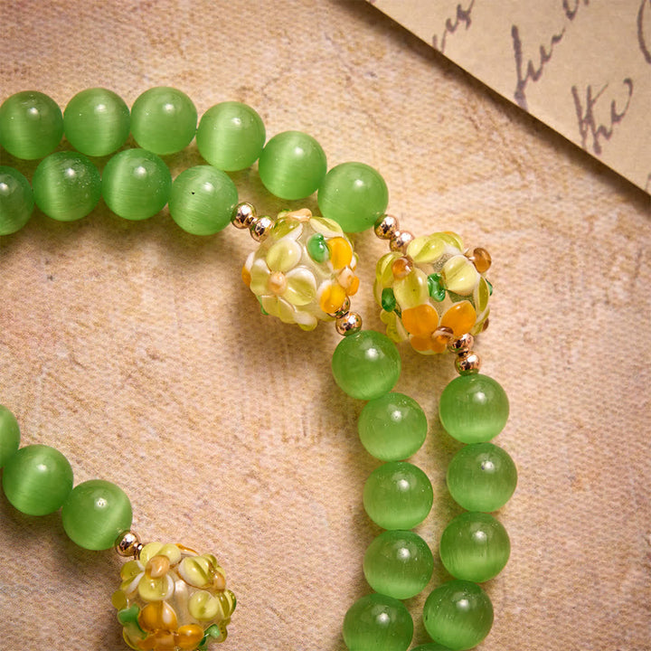 Christianartworkshop Rosario de piedra ojo de gato verde con cuentas de vidrio soplado con motivos florales: emblema de vibrantes bendiciones celestiales. - image 5