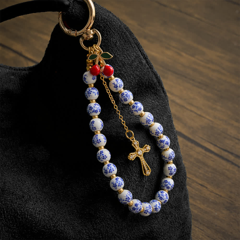 Christianartworkshop Colgante para bolso con forma de cereza y cuentas de porcelana con diseño floral, adornado con una cruz enjoyada: emblema de la dulce gracia celestial. - dije de cereza de cerámica floral - image 0