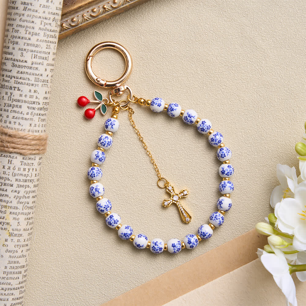 Christianartworkshop Colgante para bolso con forma de cereza y cuentas de porcelana con diseño floral, adornado con una cruz enjoyada: emblema de la dulce gracia celestial. - image 1